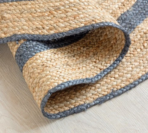 Woven mat with blue border on a light wooden floor