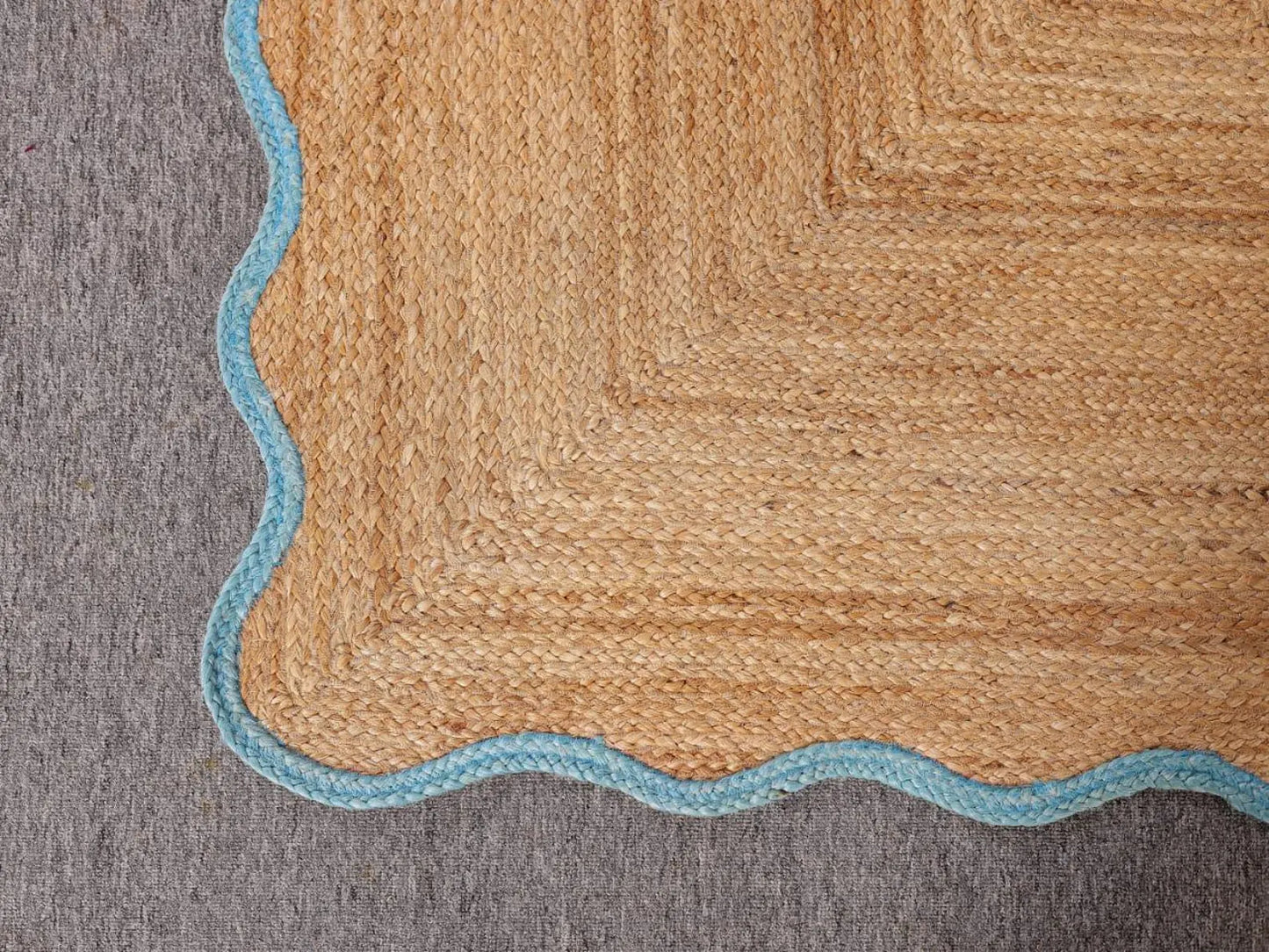 Textured rug with a geometric pattern on a gray background