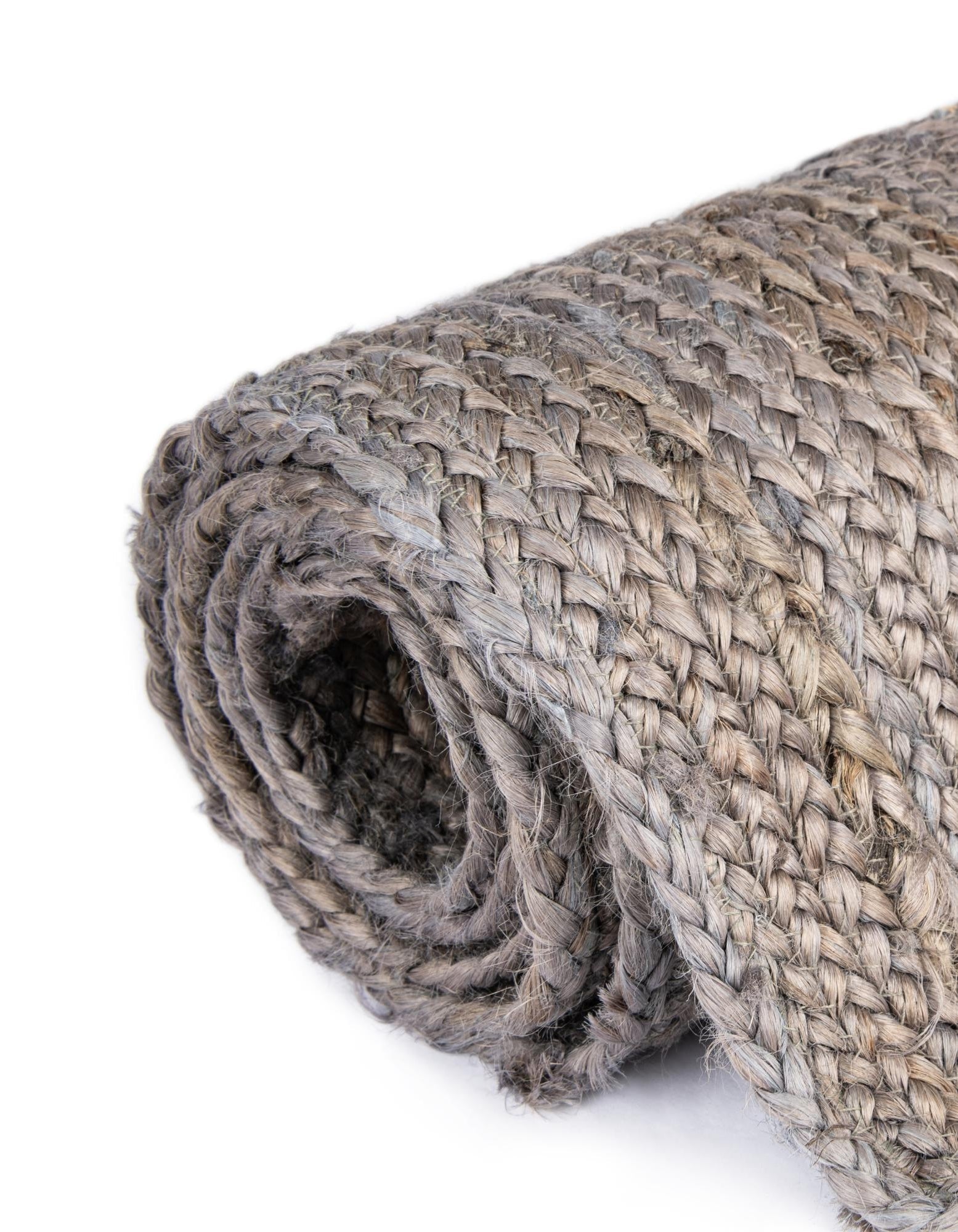 Rolled-up woven mat on a white background