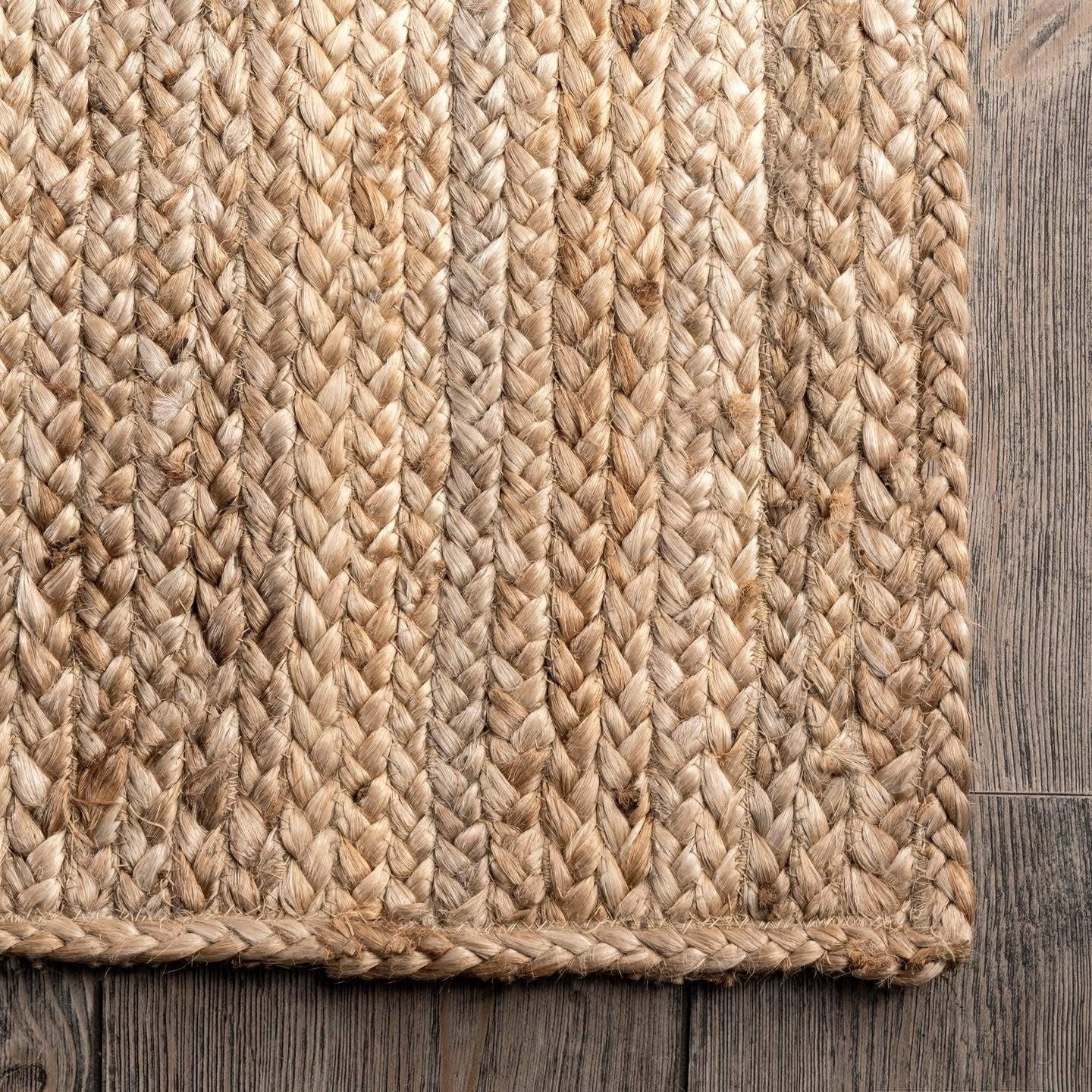 Close-up of a braided jute rug on a wooden floor