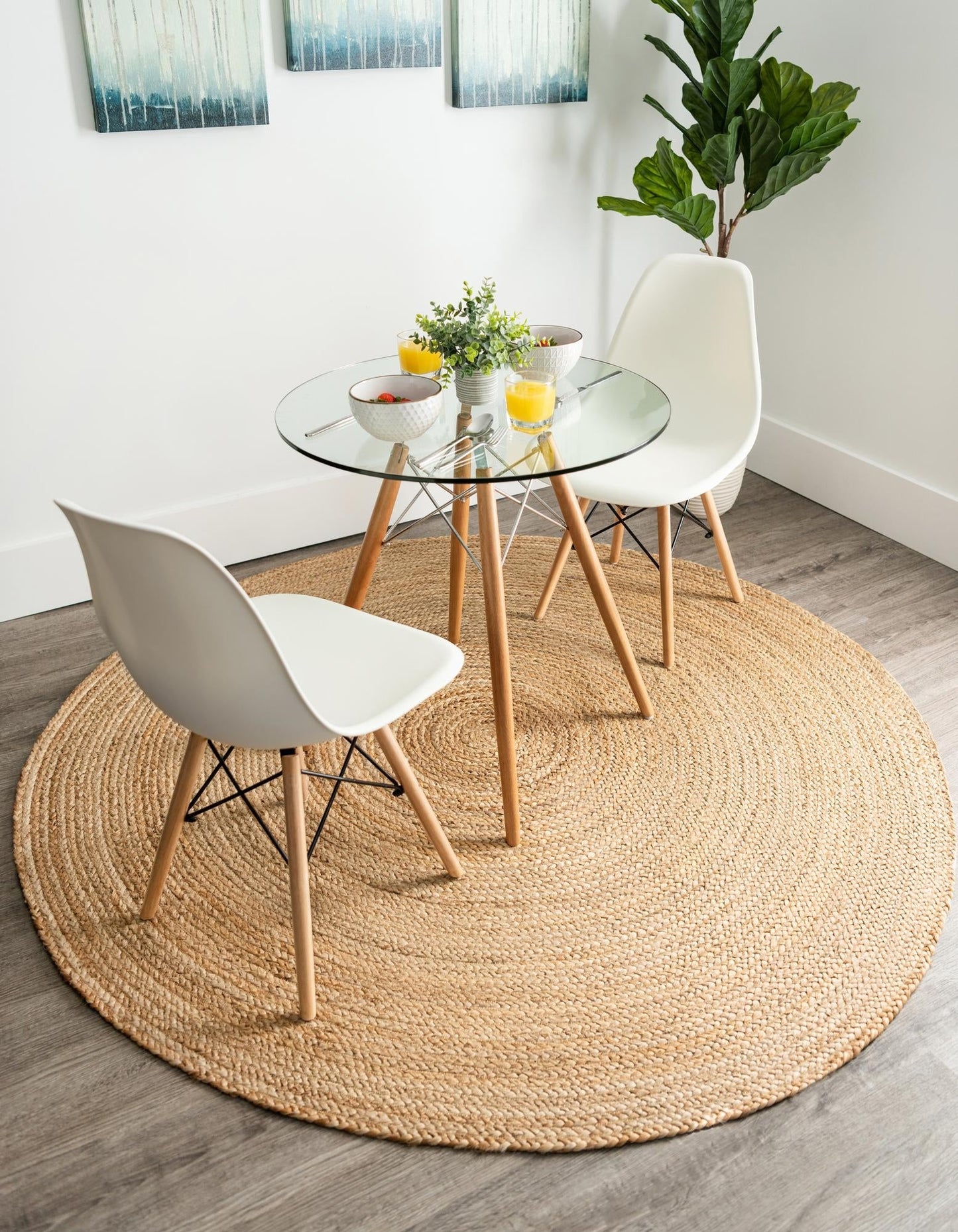 Round jute rug in a room with a glass dining table and chairs.