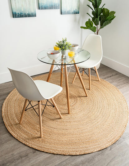 Round jute rug in a room with a glass dining table and chairs.