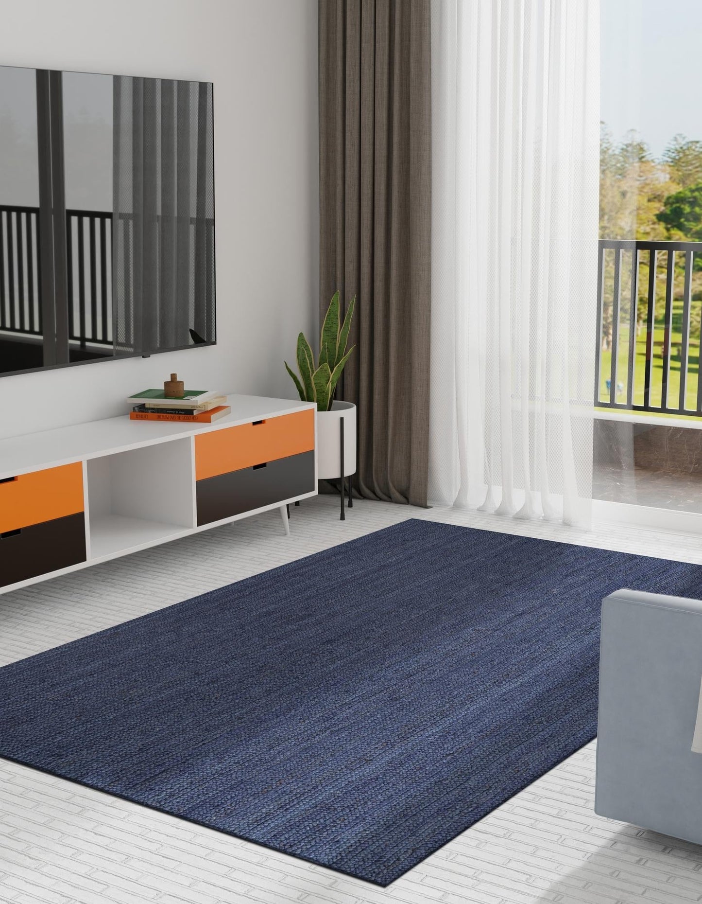 Modern living room with a blue rug, white furniture, and large windows.