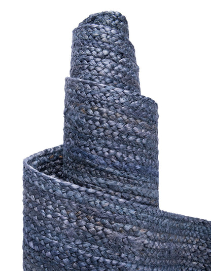 Close-up of a roll of blue textured fabric on a white background