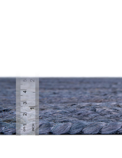 Textured blue carpet with a ruler for scale on a white background