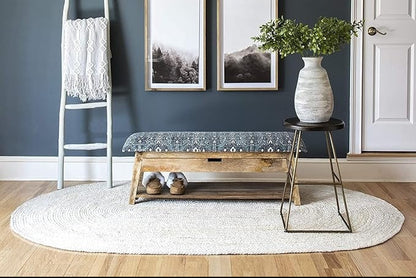 Modern interior with a ladder, bench, and decorative items against a dark blue wall.