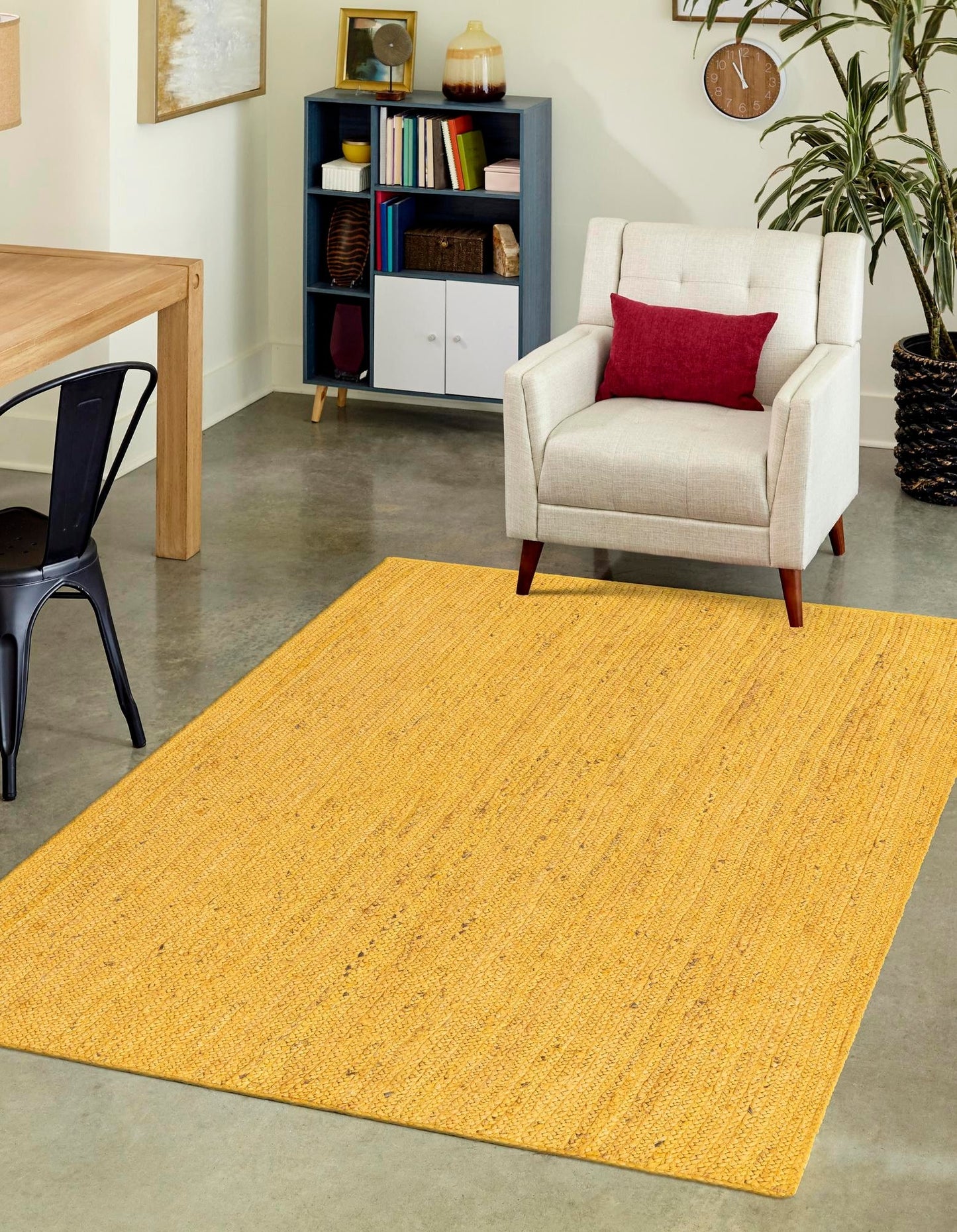 Yellow rug in a living room with a chair and bookshelf.