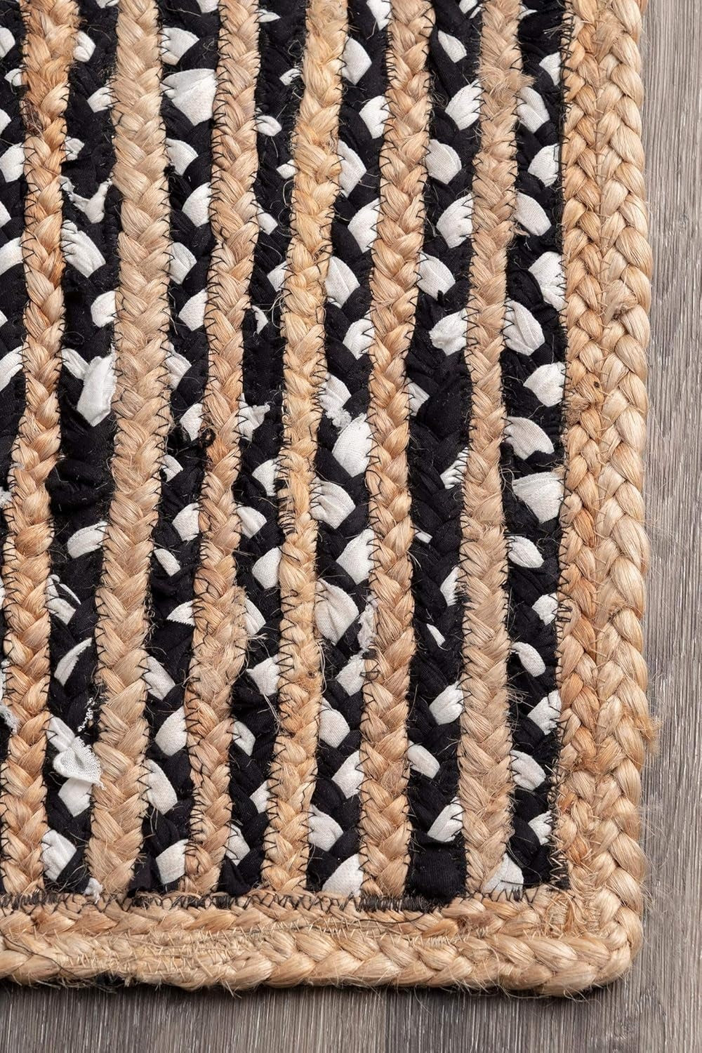 Textured rug with braided pattern on a wooden floor