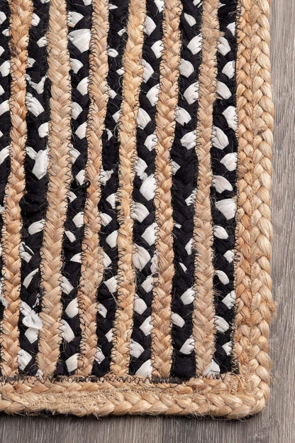 Textured rug with braided pattern on a wooden floor