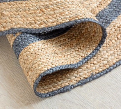 Woven mat with blue border on a light wooden floor