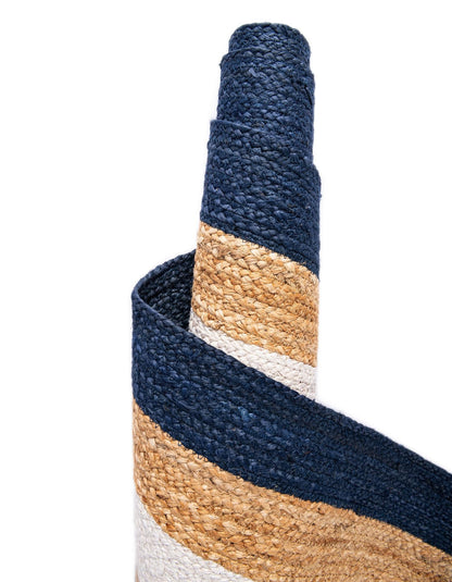 Close-up of a woven basket with blue, beige, and white stripes on a white background