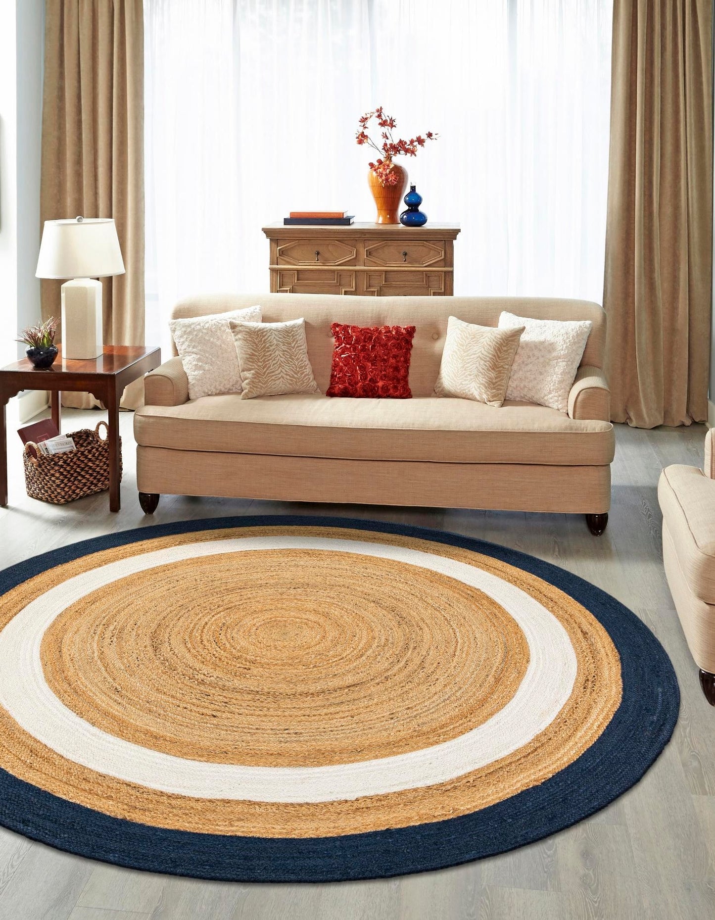 Living room with a round jute rug, beige sofa, and decorative items.