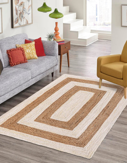 Living room with a patterned rug, gray sofa, and colorful pillows.