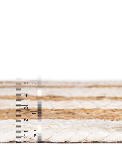 Close-up of braided rope with a ruler for scale on a white background