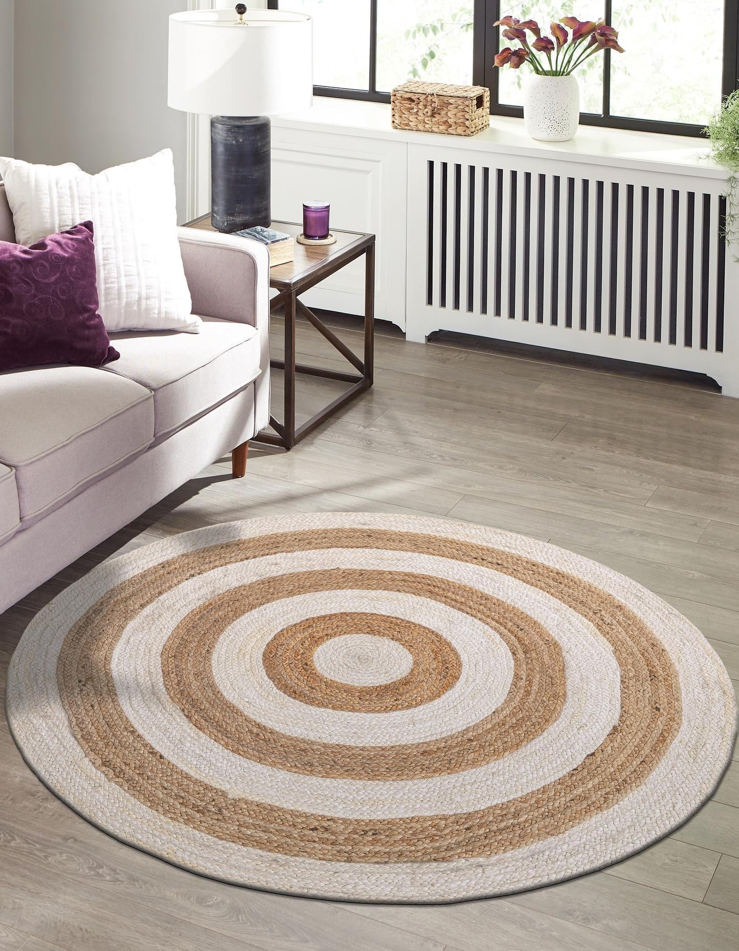Round woven rug with concentric circles in a living room setting.
