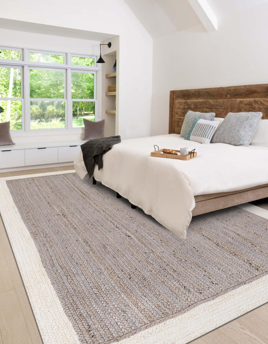 Bedroom with a large bed, wooden headboard, and a rug on the floor.