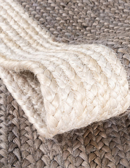 Close-up of a braided beige rug with a textured pattern