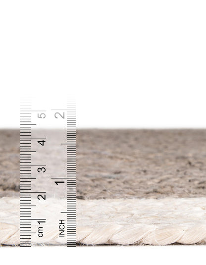 Close-up of a rope with a ruler for scale on a neutral background