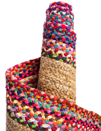 Multicolored braided rug with natural fiber base on a white background