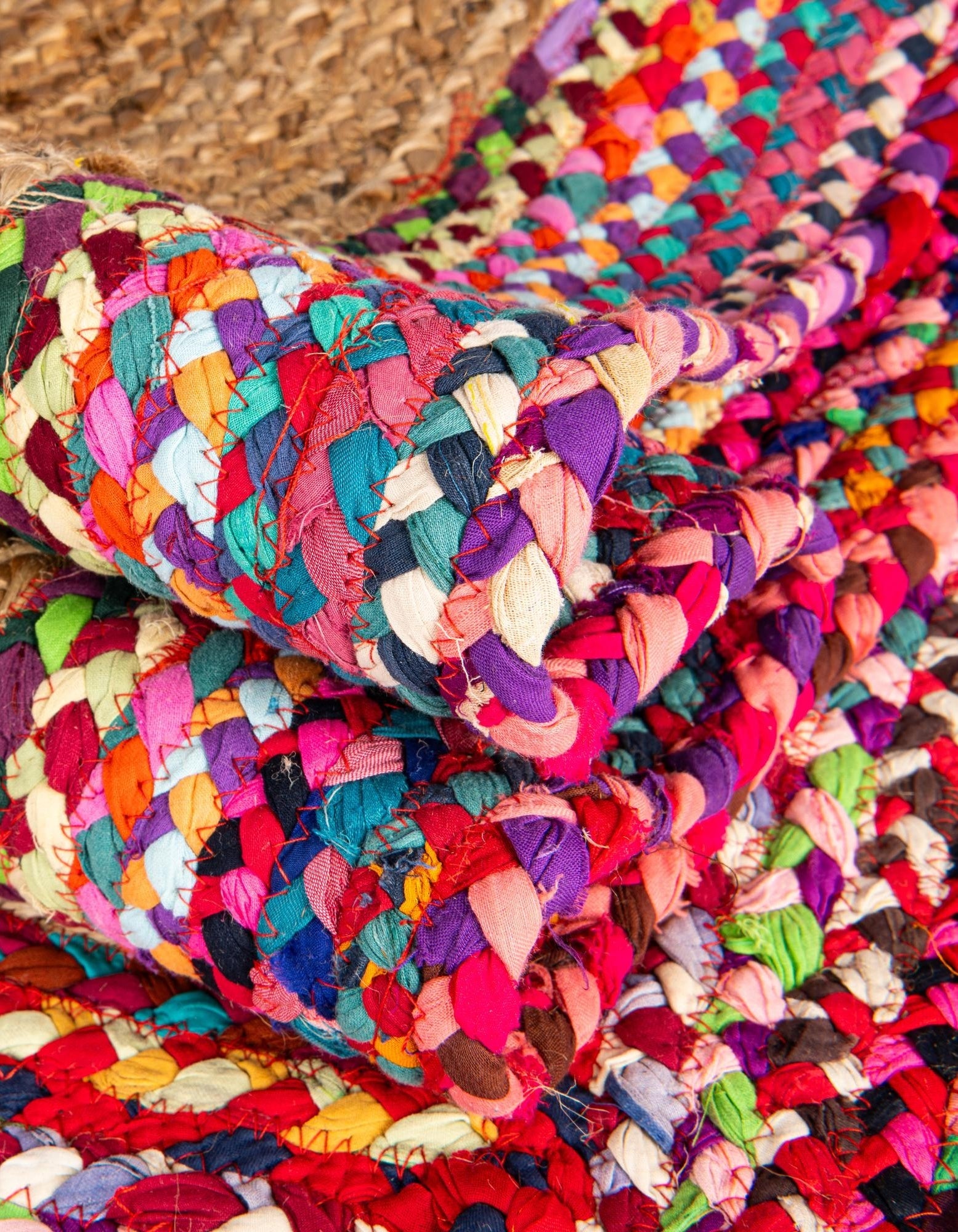 Multicolored braided rug on a wooden floor