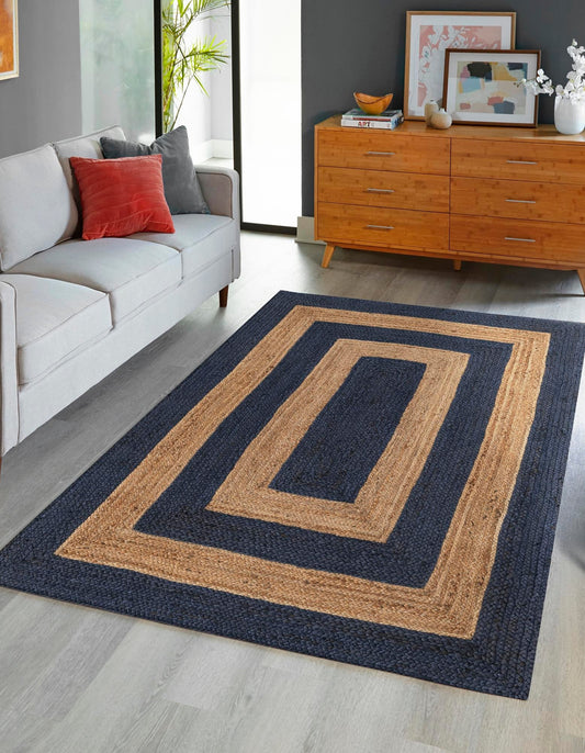 Rectangular rug with concentric rectangle pattern in a living room setting.