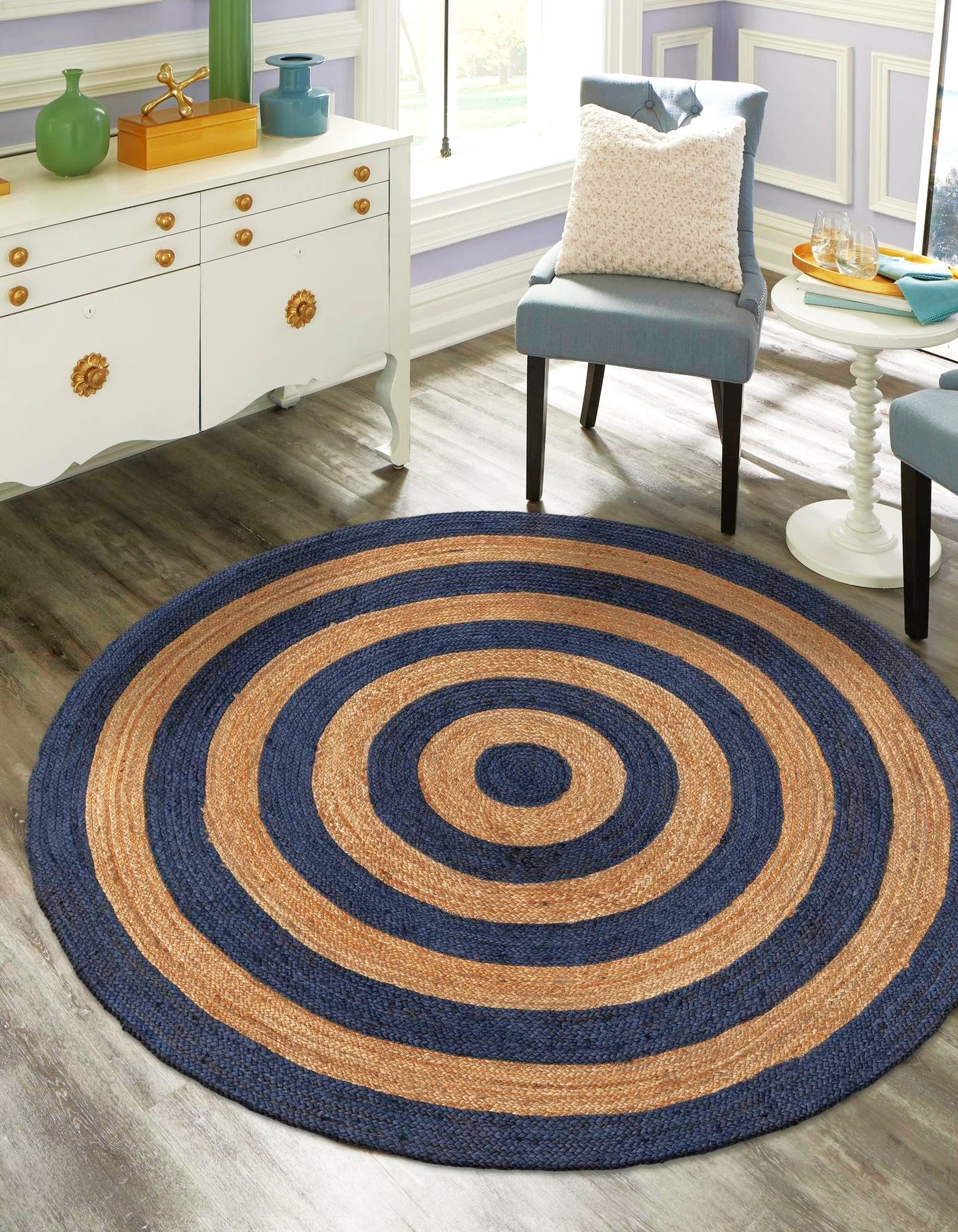 Round blue and brown striped rug in a room with furniture and decor.
