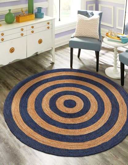 Round blue and brown striped rug in a room with furniture and decor.