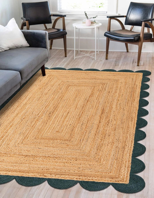 Living room with a large natural jute rug, gray sofa, black chairs, and a small round table.
