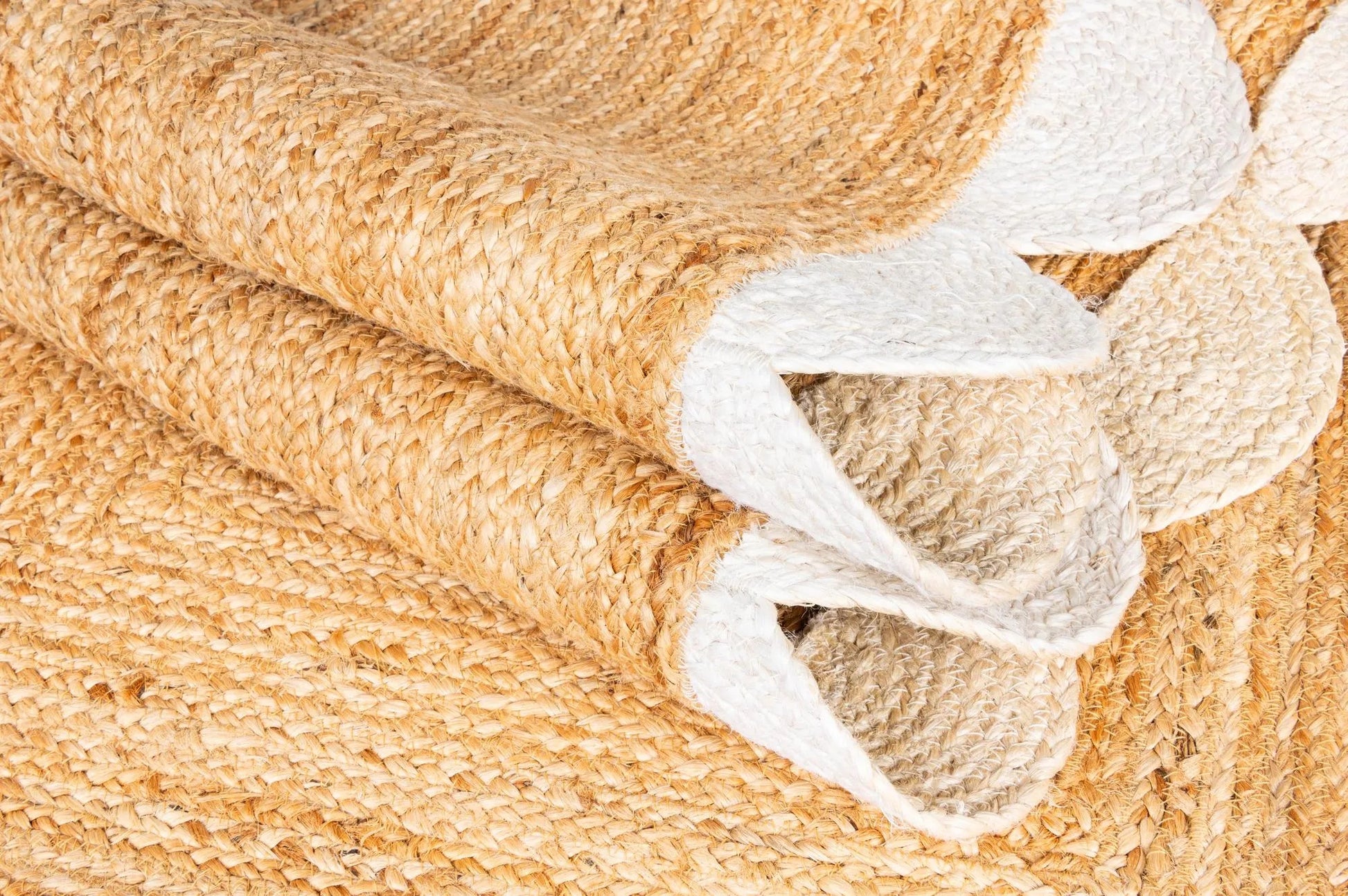Close-up of beige and white textured fabric rolls