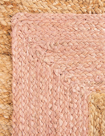 Close-up of a pink woven mat on a textured surface