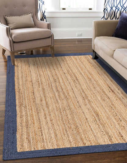 Beige rug with blue border in a living room setting