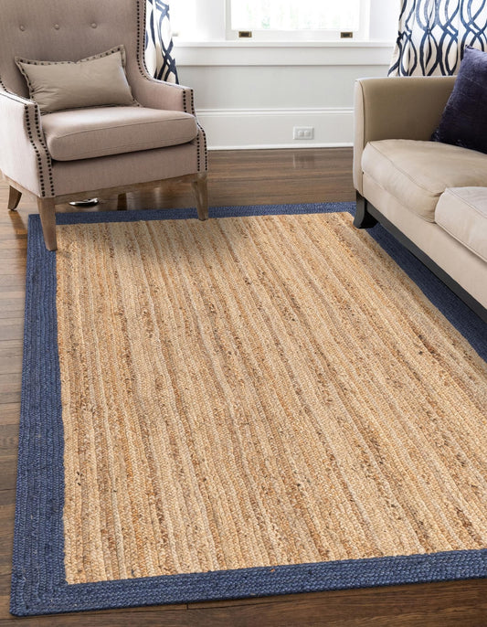 Beige rug with blue border in a living room setting
