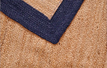 Close-up of a textured rug with a blue border