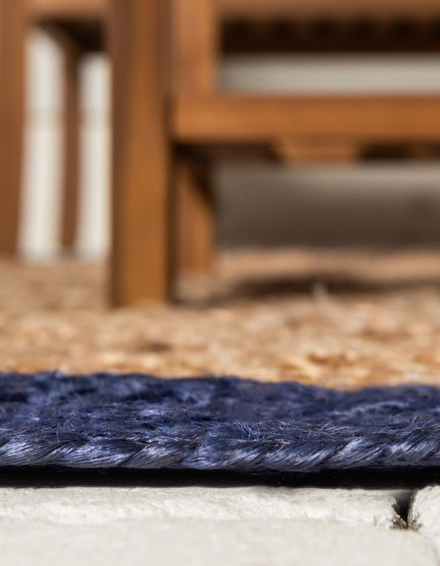 Close-up of a blue rug with wooden furniture in the background