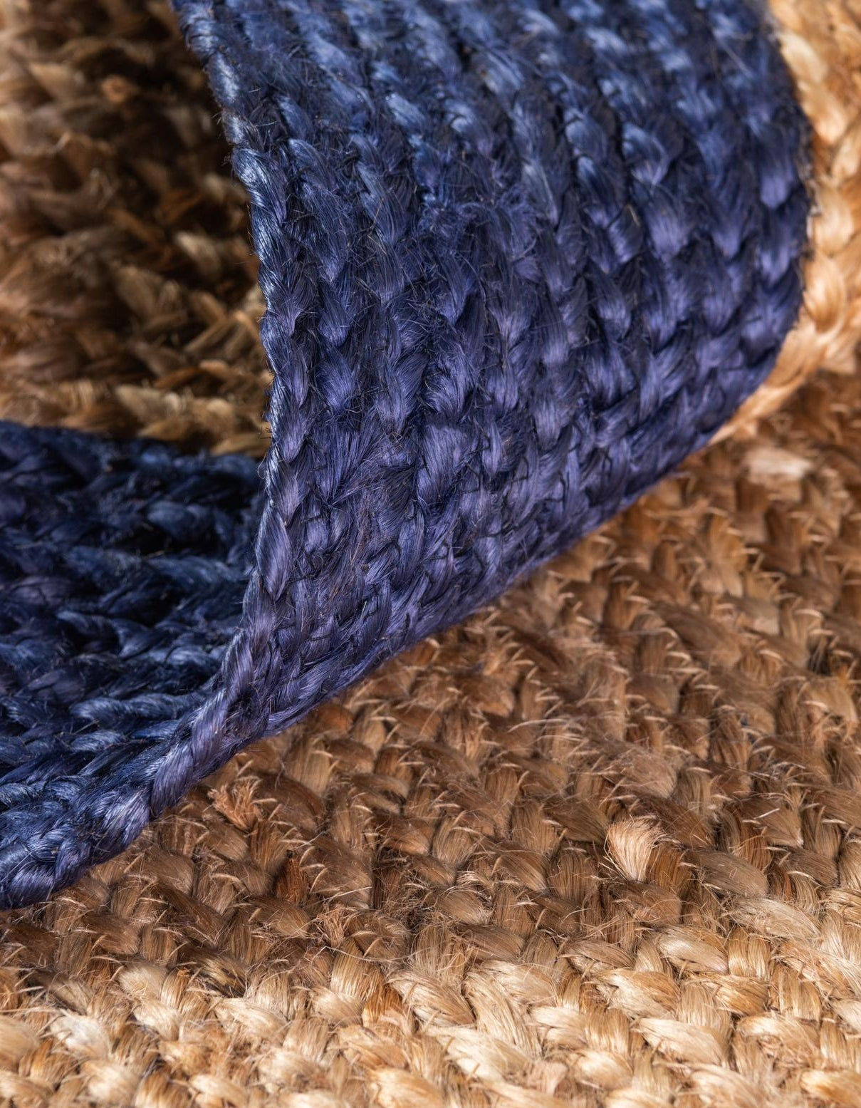 Close-up of a blue textured fabric edge on a brown woven surface
