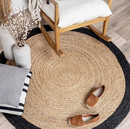 Round woven rug with a chair, shoes, and decorative items on a wooden floor.