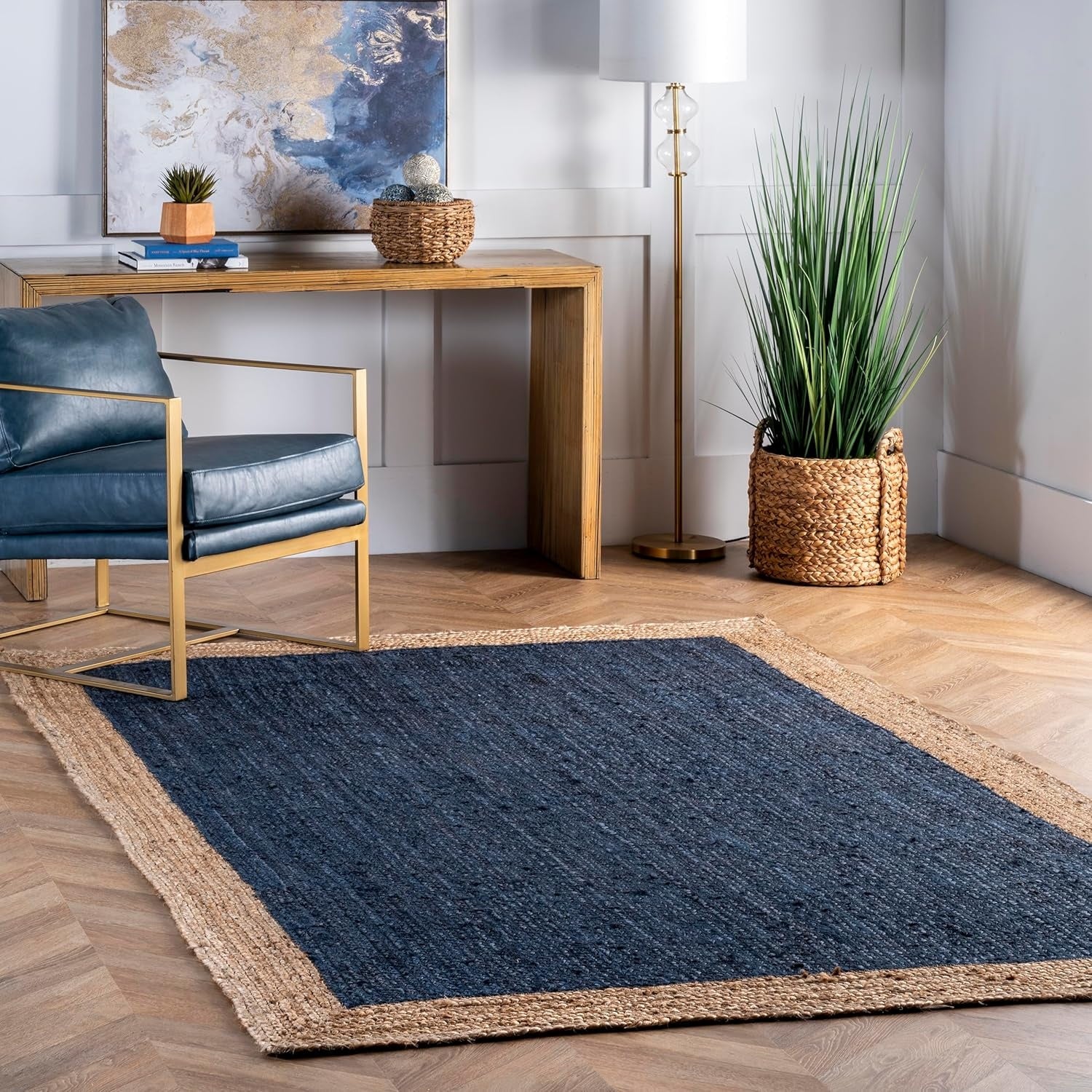 Modern office with a blue rug, wooden desk, and chair.