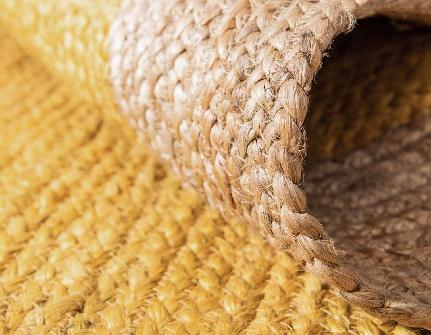 Close-up of a textured yellow and beige woven rug corner