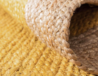 Close-up of a textured yellow and beige woven rug corner
