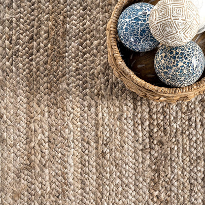 Textured woven rug with a basket containing decorative balls on a wooden floor.