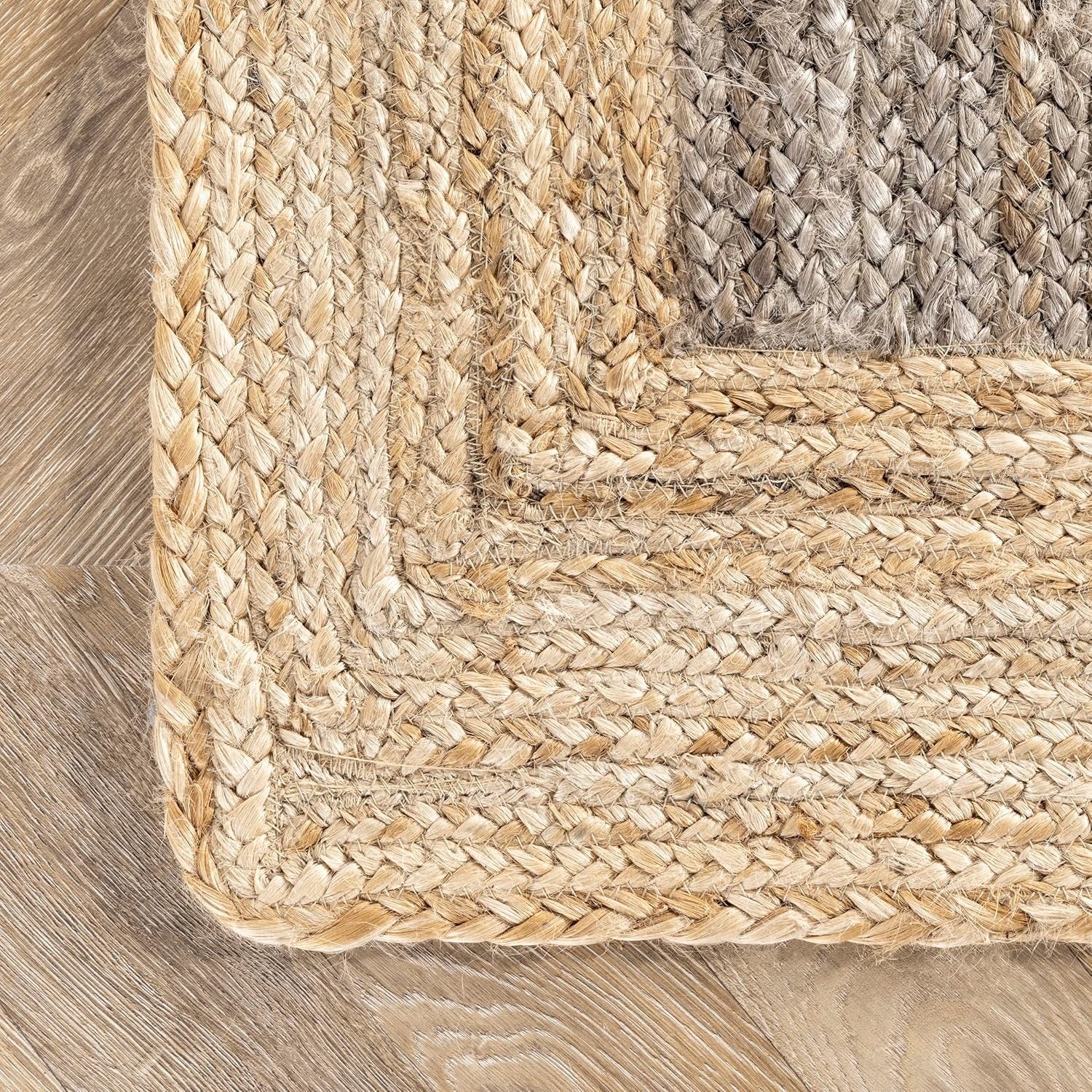 Close-up of a braided rug corner on a wooden floor