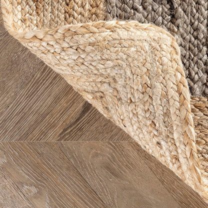 Close-up of a textured woven rug on a wooden floor