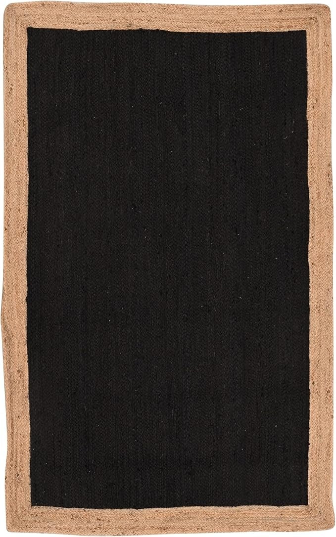 A rectangular area rug with a solid black center and a natural tan jute border, shown flat against a white background.