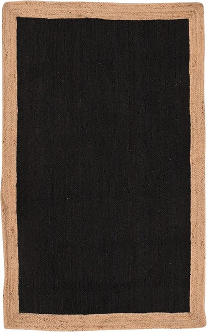 A rectangular area rug with a solid black center and a natural tan jute border, shown flat against a white background.