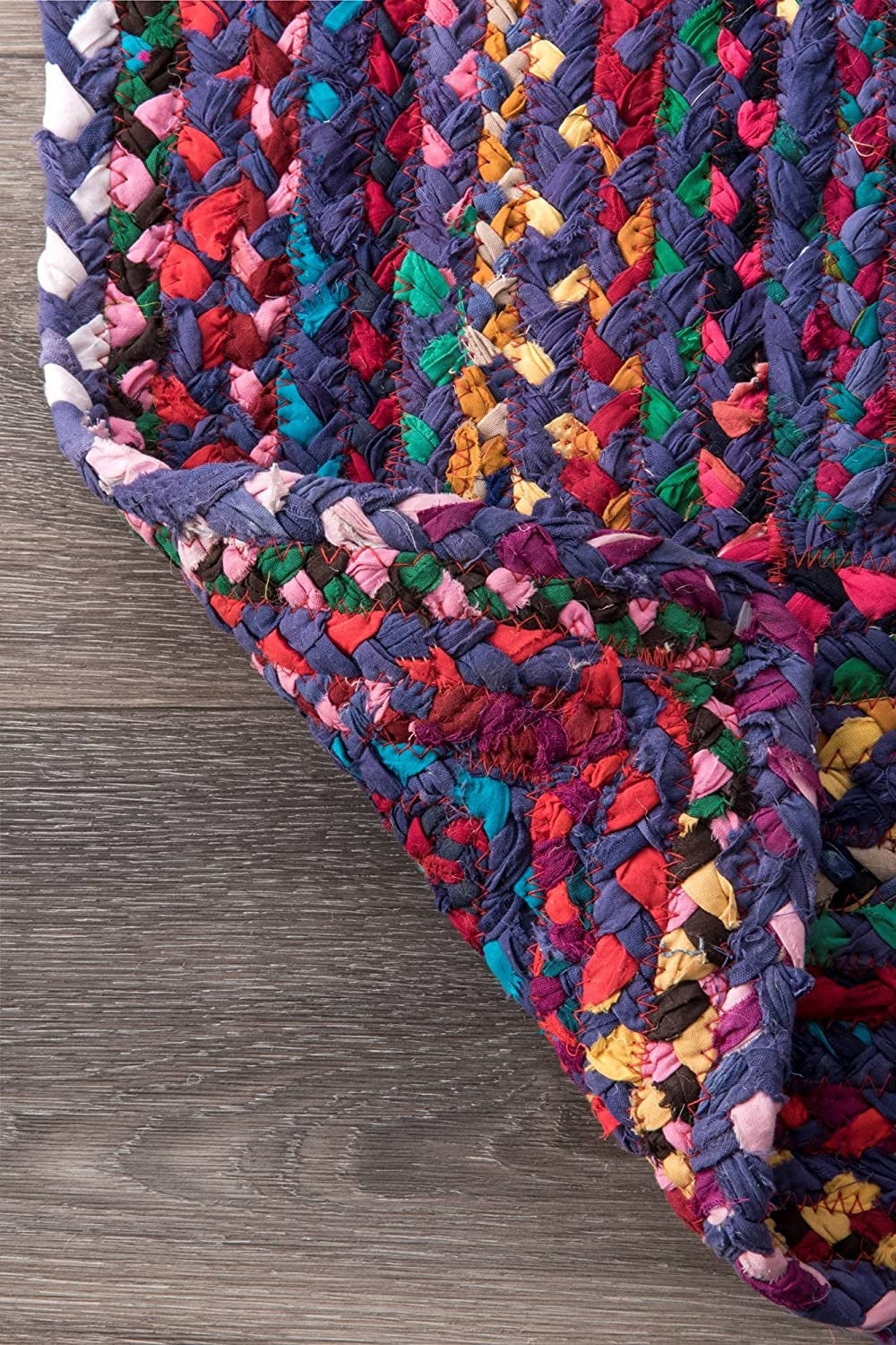 Multicolored braided rug on a wooden floor
