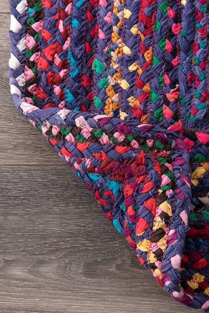 Multicolored braided rug on a wooden floor