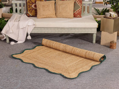 Rolled jute rug on a gray floor with a white sofa and decorative pillows in the background.