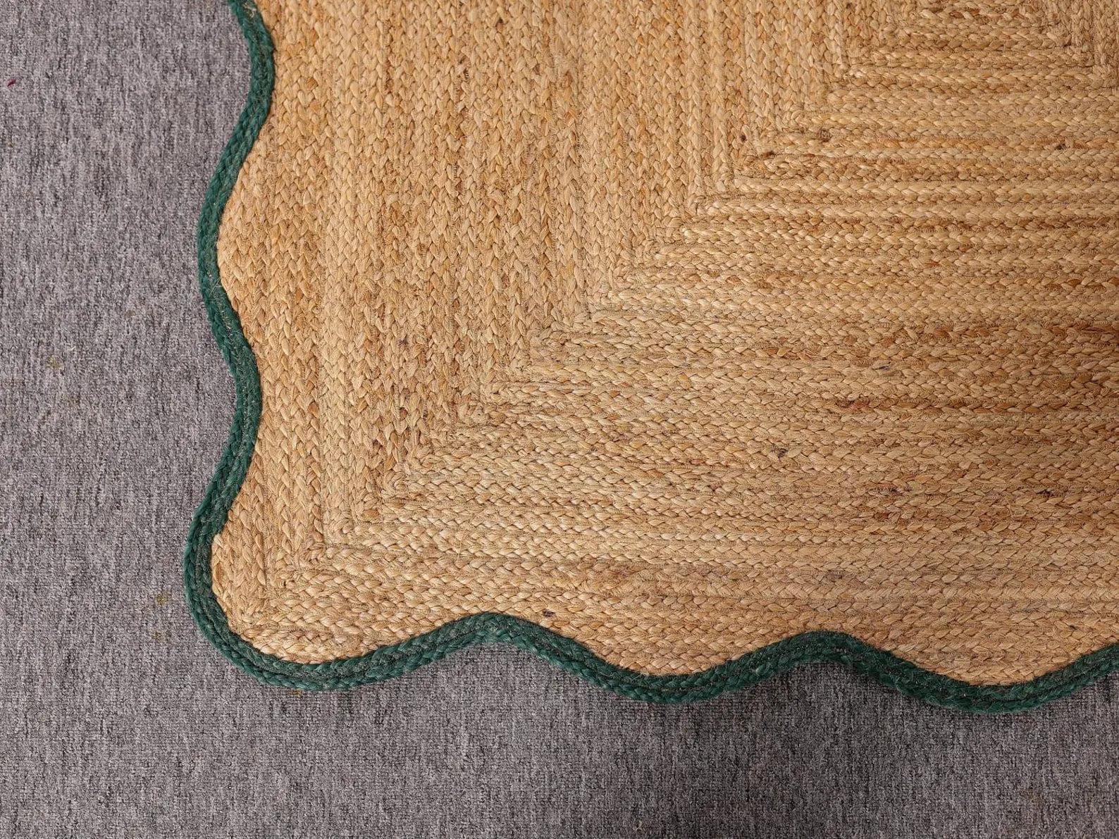 Close-up of a textured rug with geometric pattern on a gray surface
