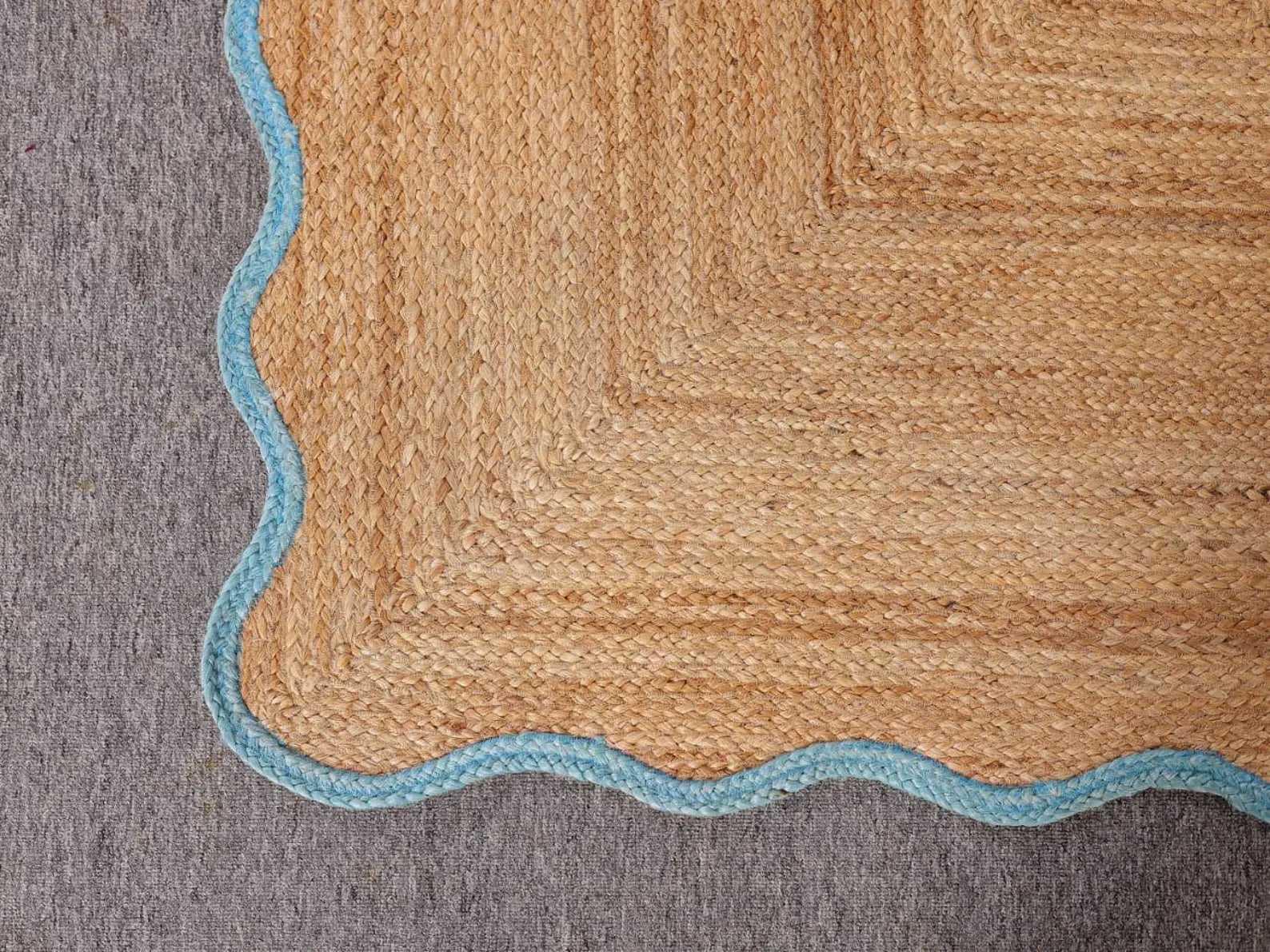 Textured rug with a geometric pattern on a gray background