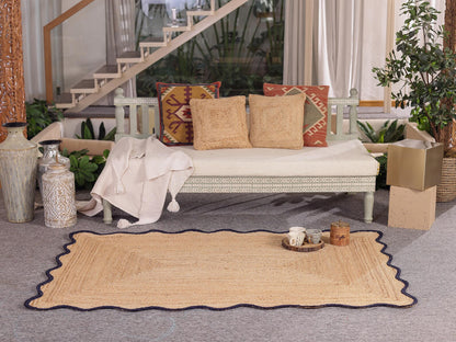 Beige rug with decorative pillows on a white sofa in a living room setting.
